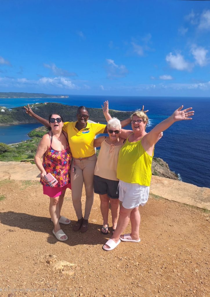 Janel from Exquisite Taxi Tours and guests take a photo at Block House in Antigua