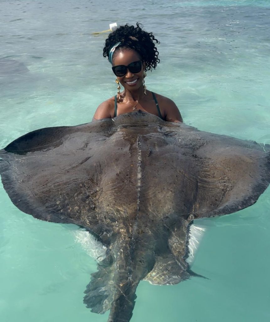 Guest posing with a large southern stingray