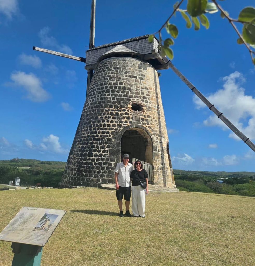 Historic Betty’s Hope windmill, a landmark of Antigua’s former sugar plantation, against a bright blue sky.