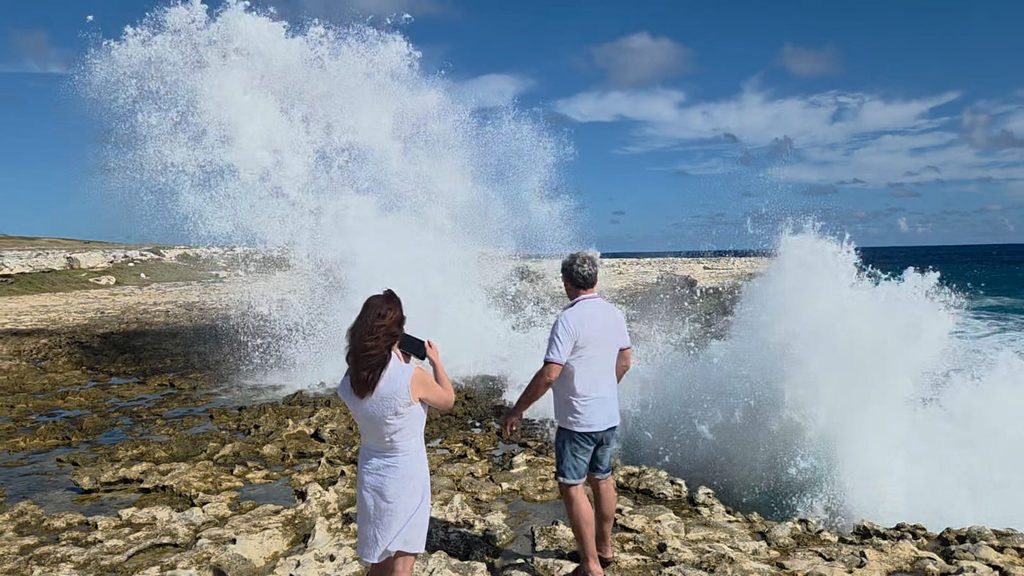 Dramatic Atlantic waves crashing against the rocky shore at Devil's Bridge in Antigua